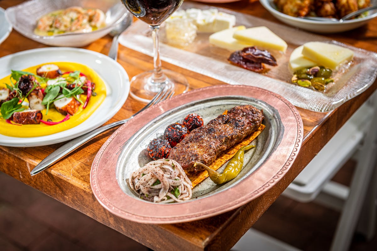 a plate full of food sitting on top of a wooden table