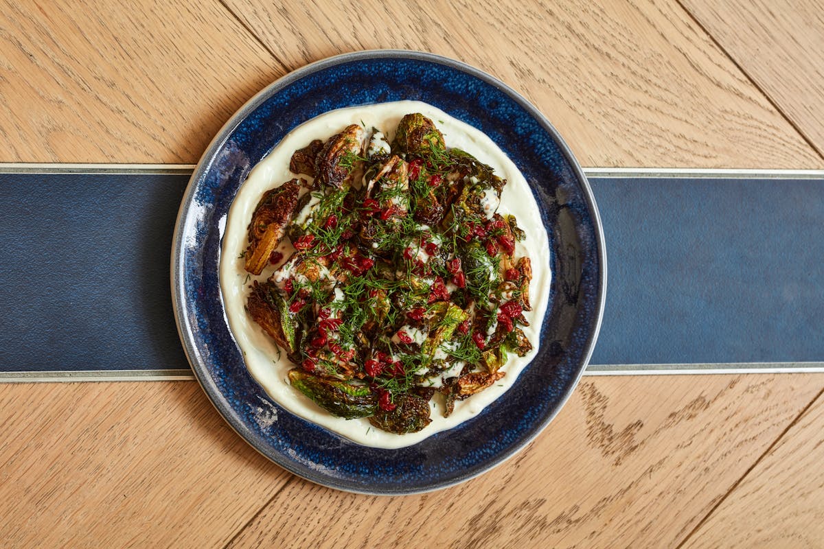 a bowl of food sitting on top of a wooden table