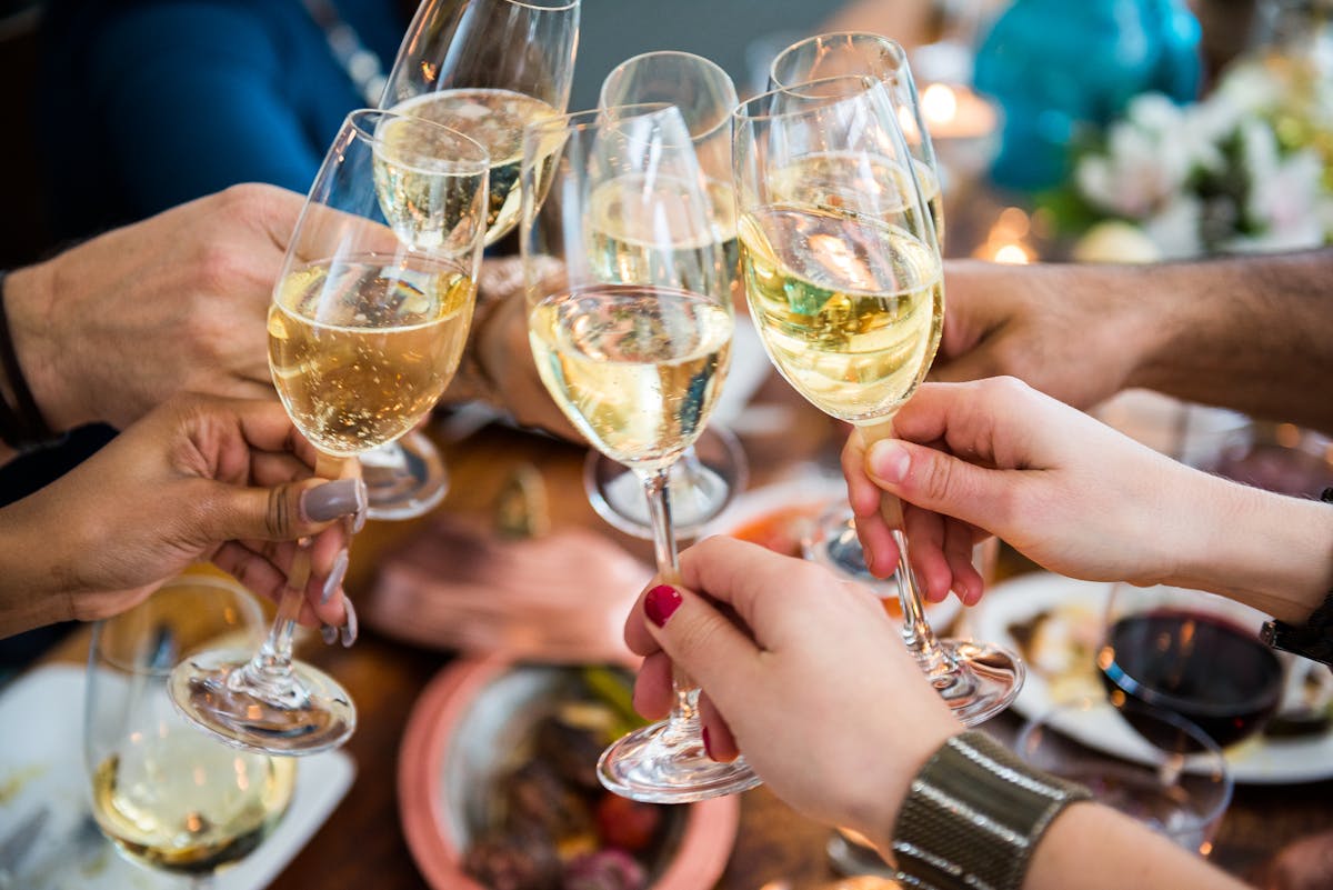 a hand holding a glass of wine