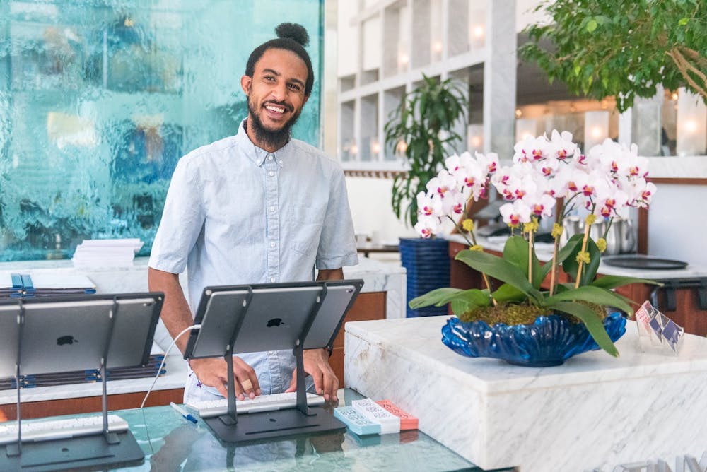 Nourdin Boukhari standing in front of a laptop