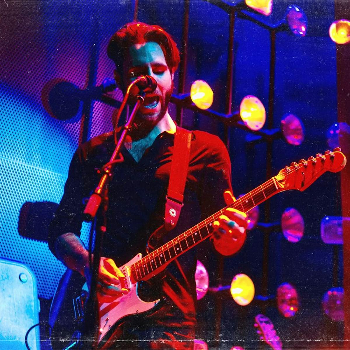 a man singing and playing the guitar