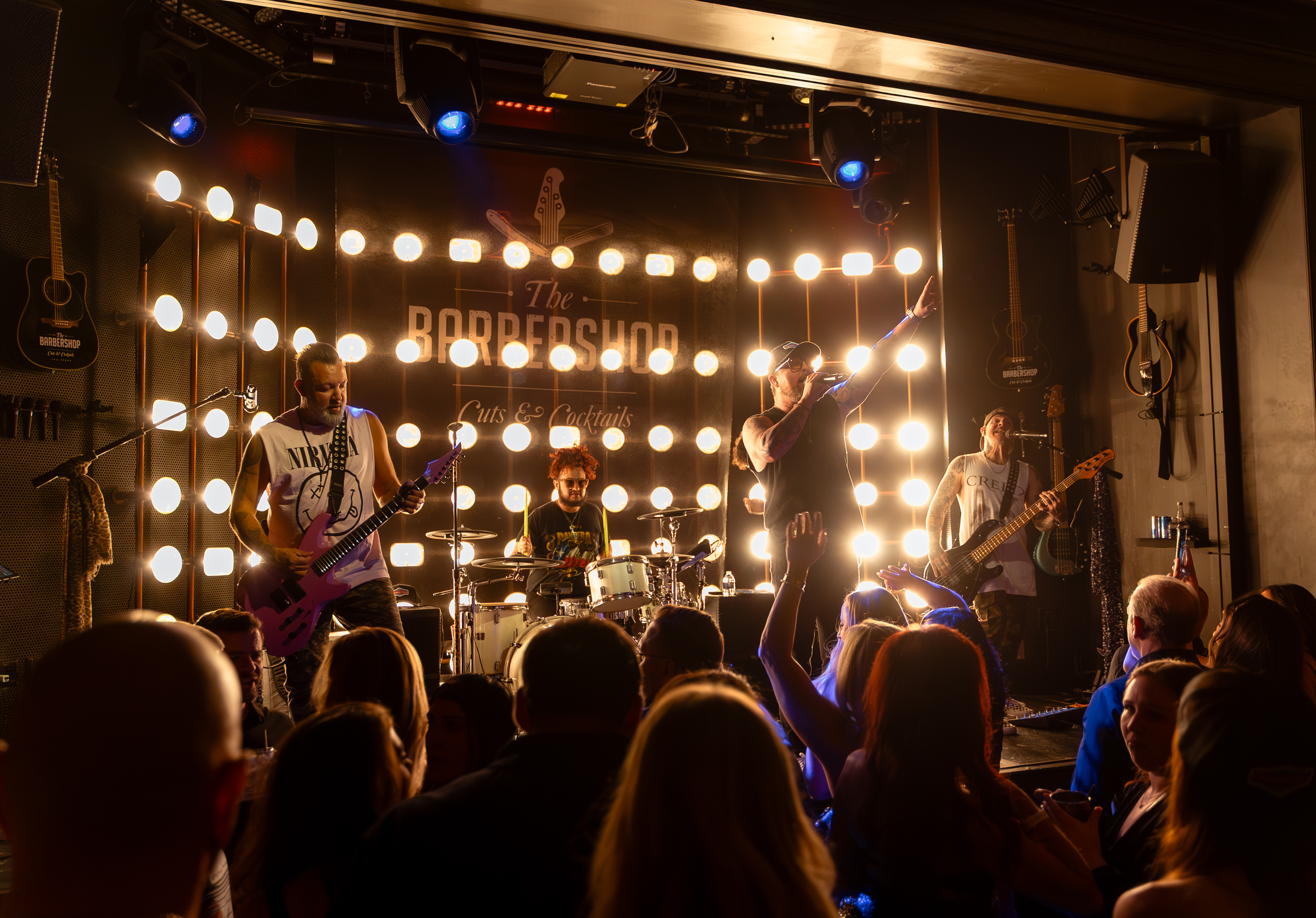 Live band on stage at the Barbershop Cuts & cocktails