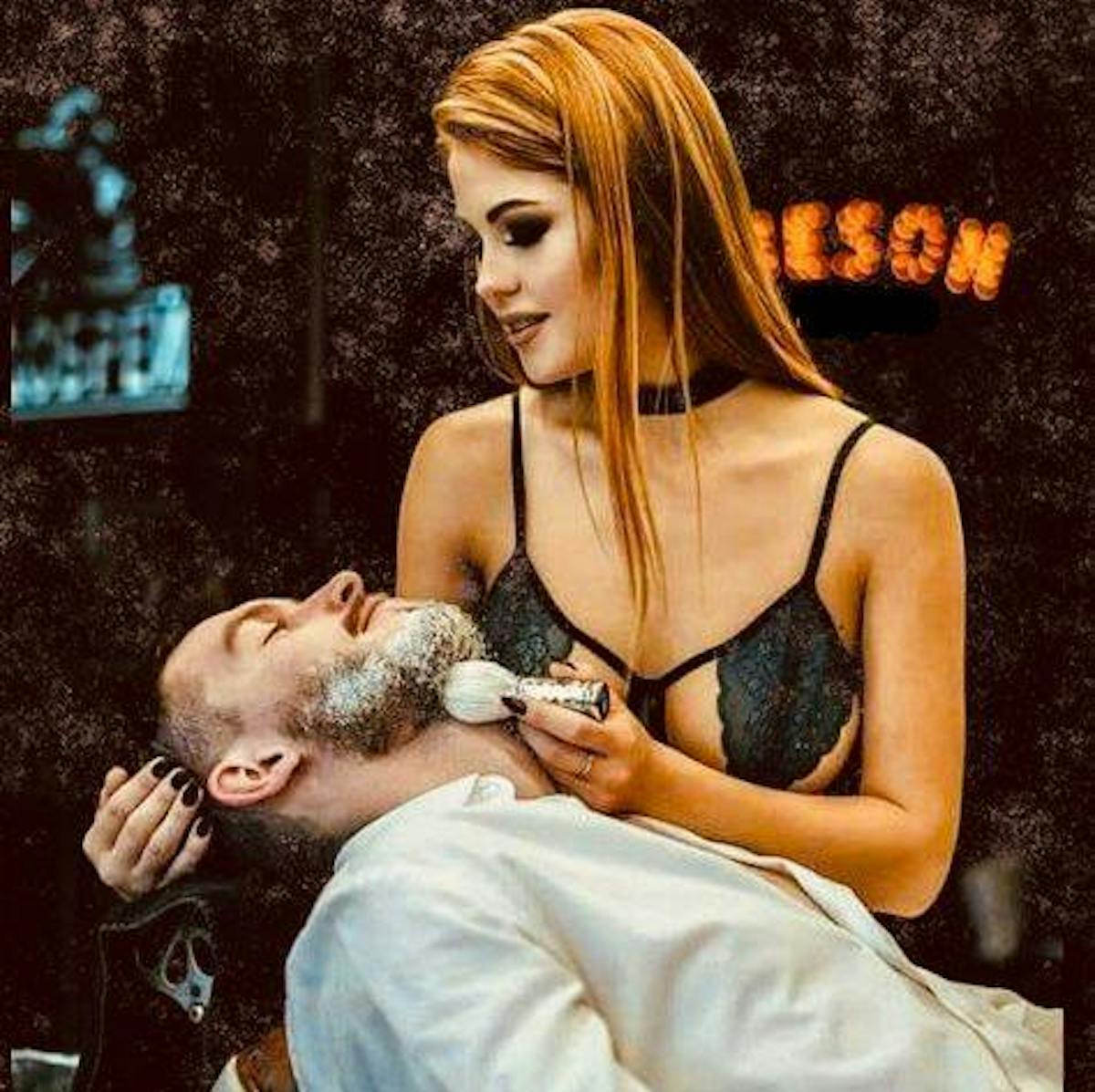 a woman shaving a mans beard