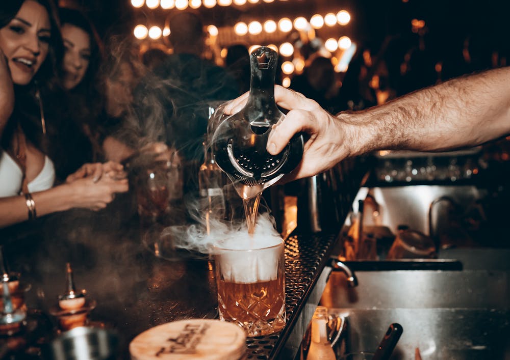 pouring a hand crafted cocktail at Barbershop Cuts & Cocktails, Las Vegas live Music