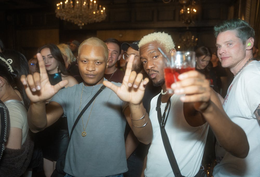 crowd enjoying the vibe and atmosphere of the barbershop cuts and cocktails