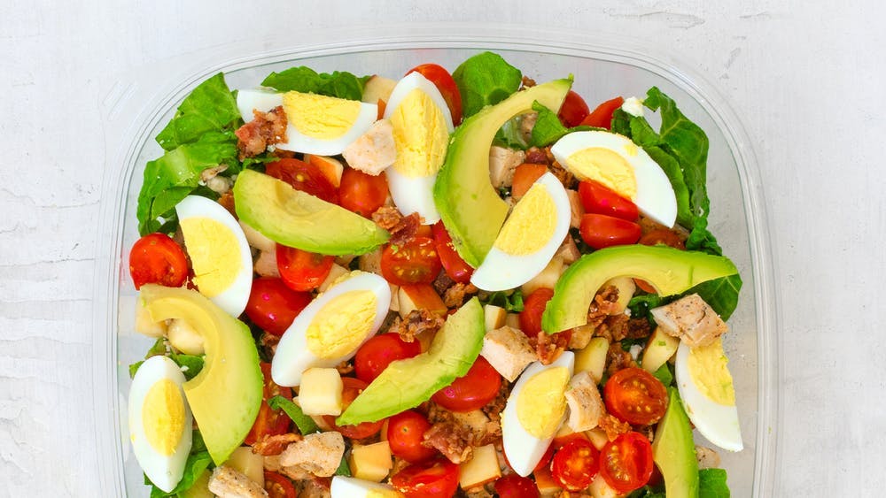a plate is filled with fresh fruit and vegetables