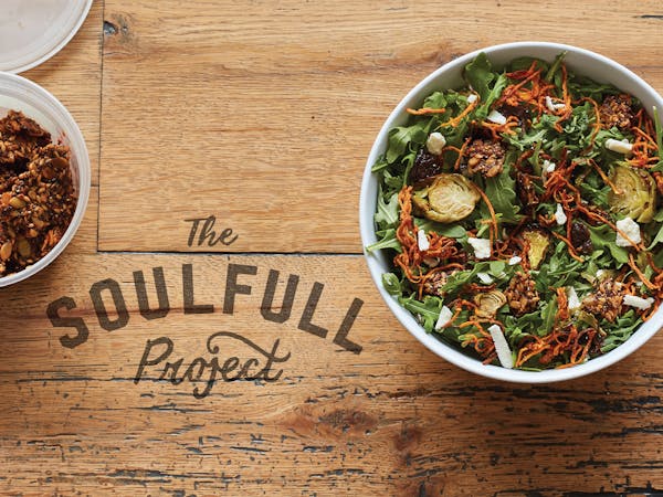 a bowl of food on a wooden table