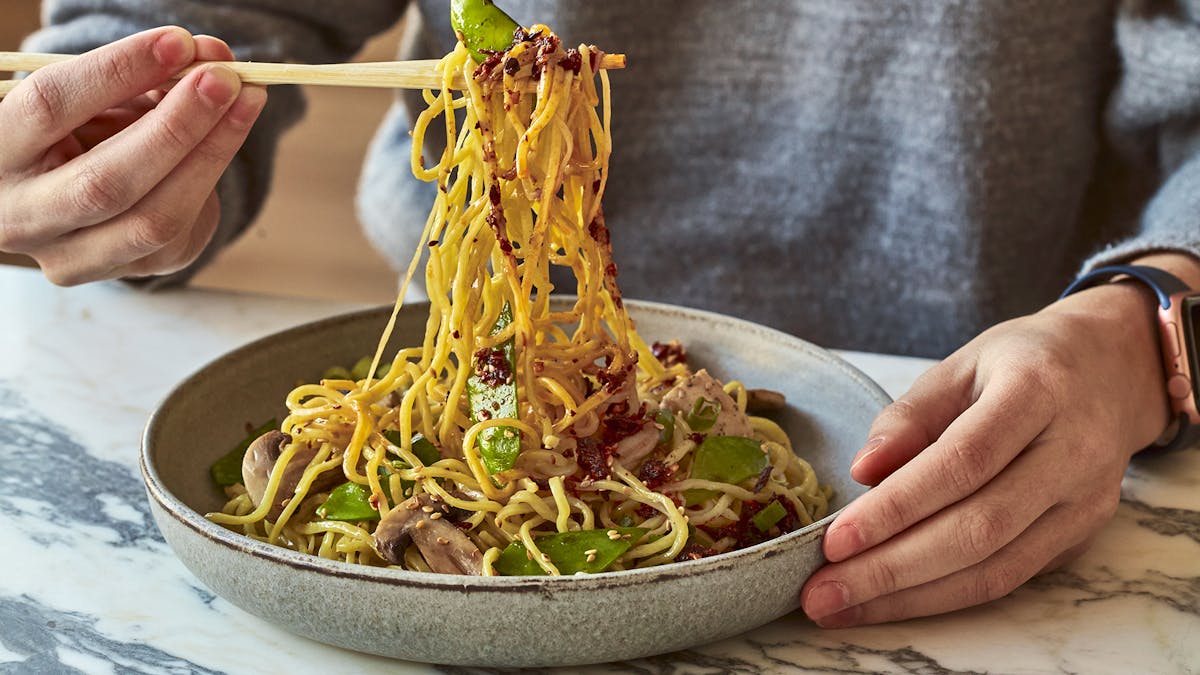 a person holding a bowl of food