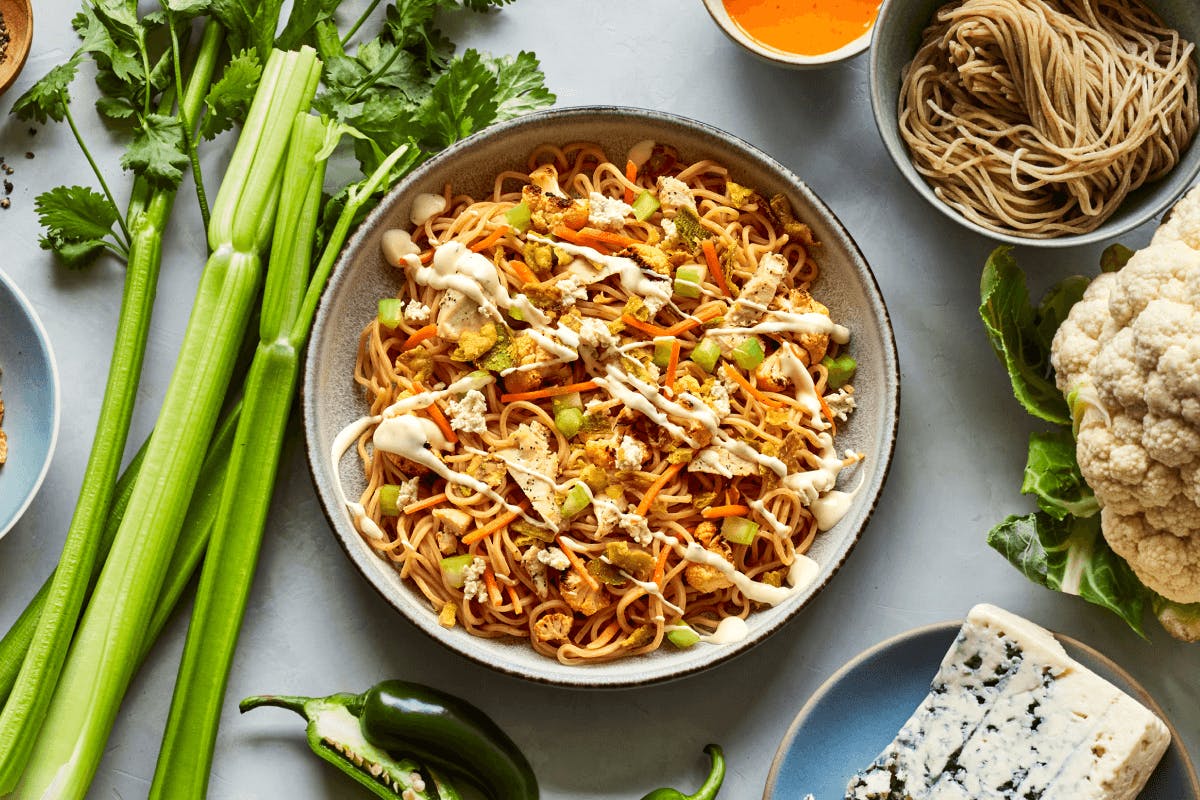 Freshly made whole wheat noodles, roasted chicken, roasted cauliflower, carrots, celery, crispy jalapeños, crumbled blue cheese, buffalo sauce, and a drizzle of ranch dressing.
