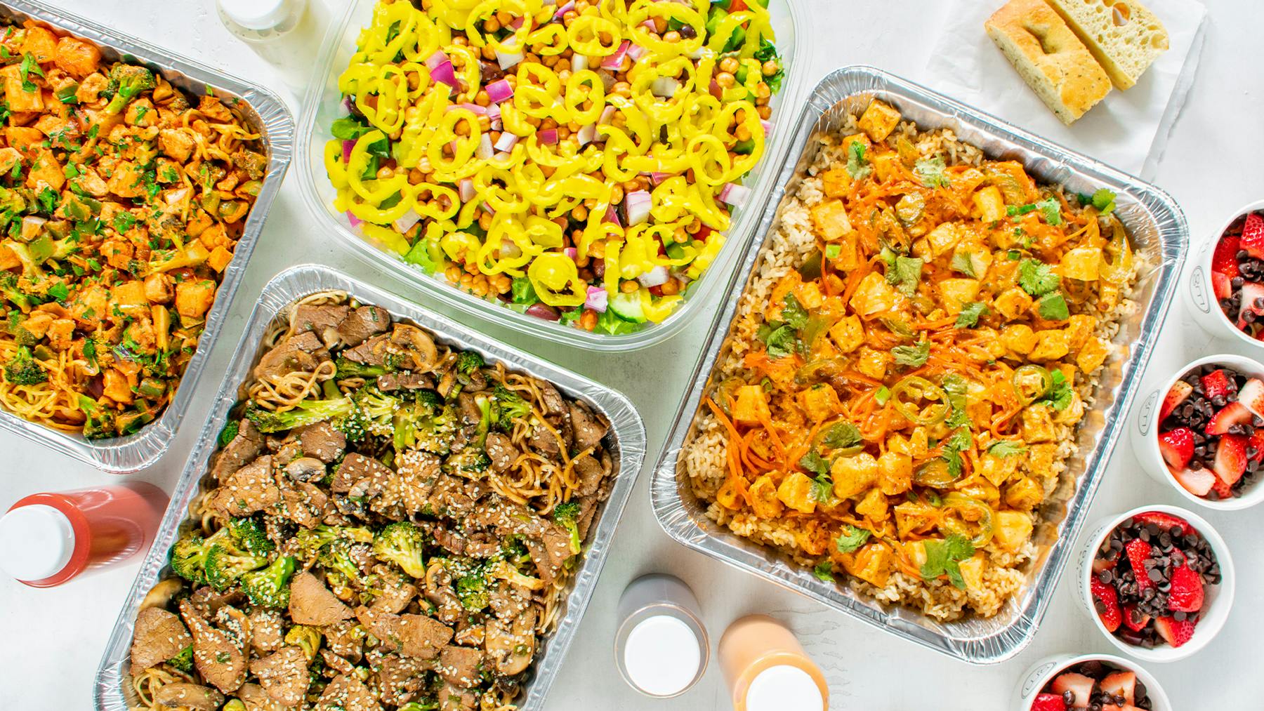 a plastic container filled with different types of food on a table
