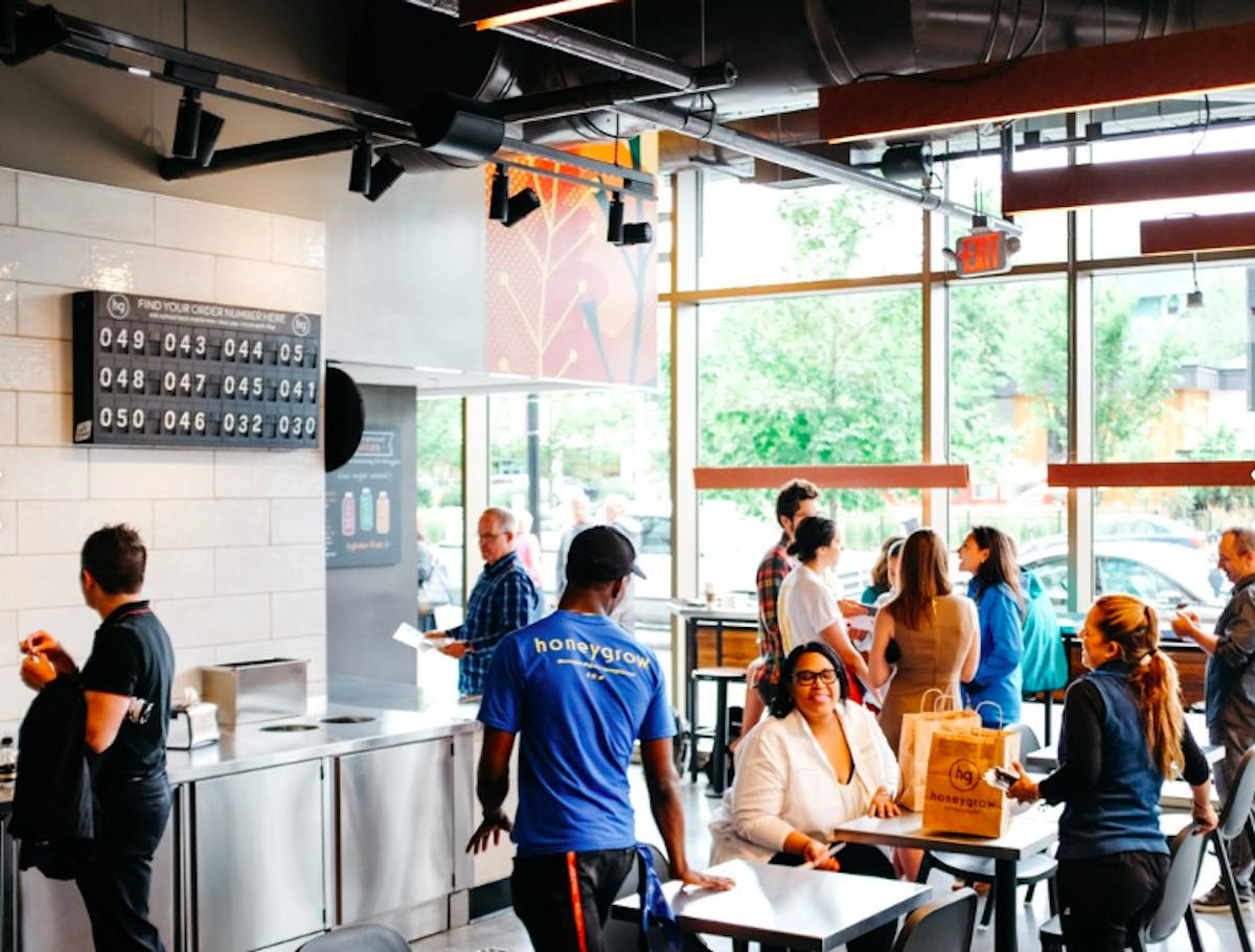 a group of people preparing food in a restaurant