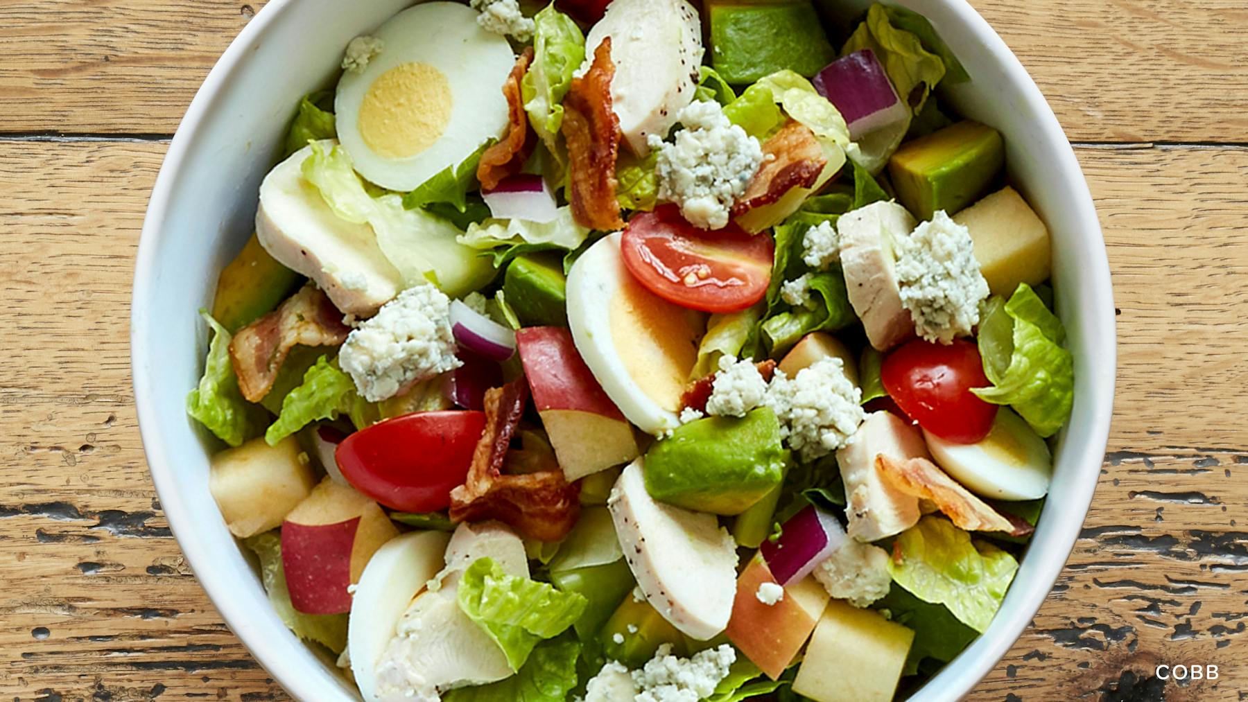 a bowl of fruit and vegetable salad on a plate