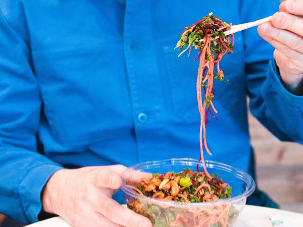a man eating eating food from a bowl