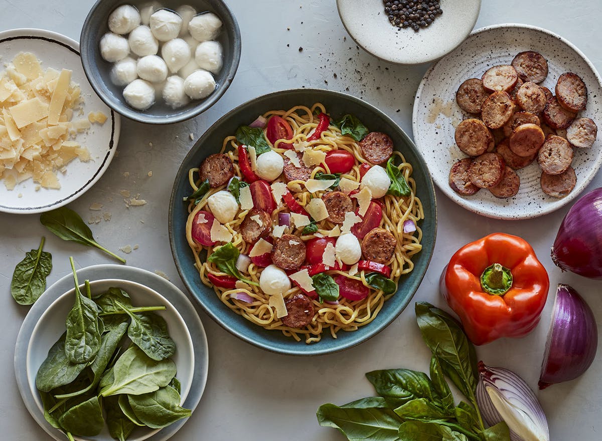 Freshly made egg white noodles, sweet Italian sausage, fresh mozzarella, red onions, organic baby spinach, roasted red peppers, grape tomatoes, chili flakes, shaved parmesan, and our tomato-basil broth.