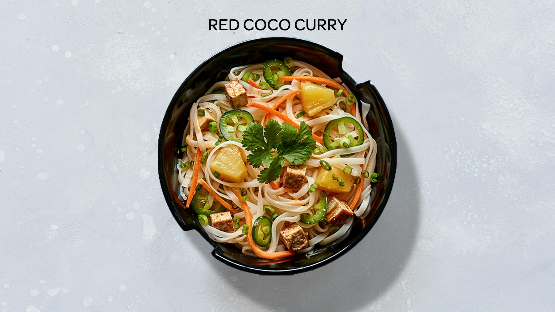 a bowl of red coconut curry stir-fry