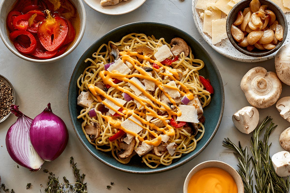 honeygrow's summer seasonal stir-fry: Spicy Chicken Cheesesteak. Freshly made egg white noodles, roasted chicken, mushrooms, red onions, spicy cherry peppers, shaved parmesan, cheese whiz, and our garlic herb au jus.