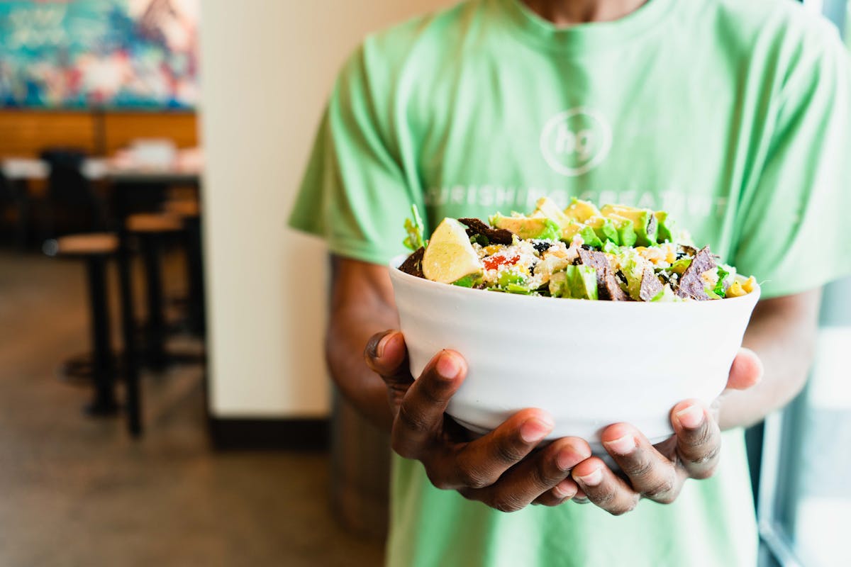 a person holding a plate of food