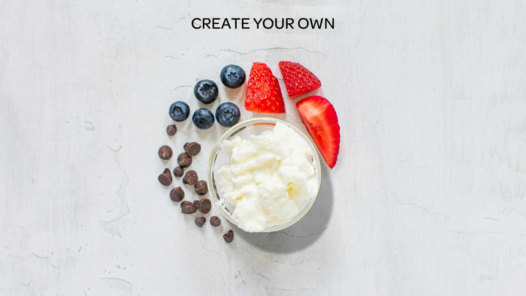 whipped cream, fruit and chocolate chips spread out on a table to represent a create your own honeybar