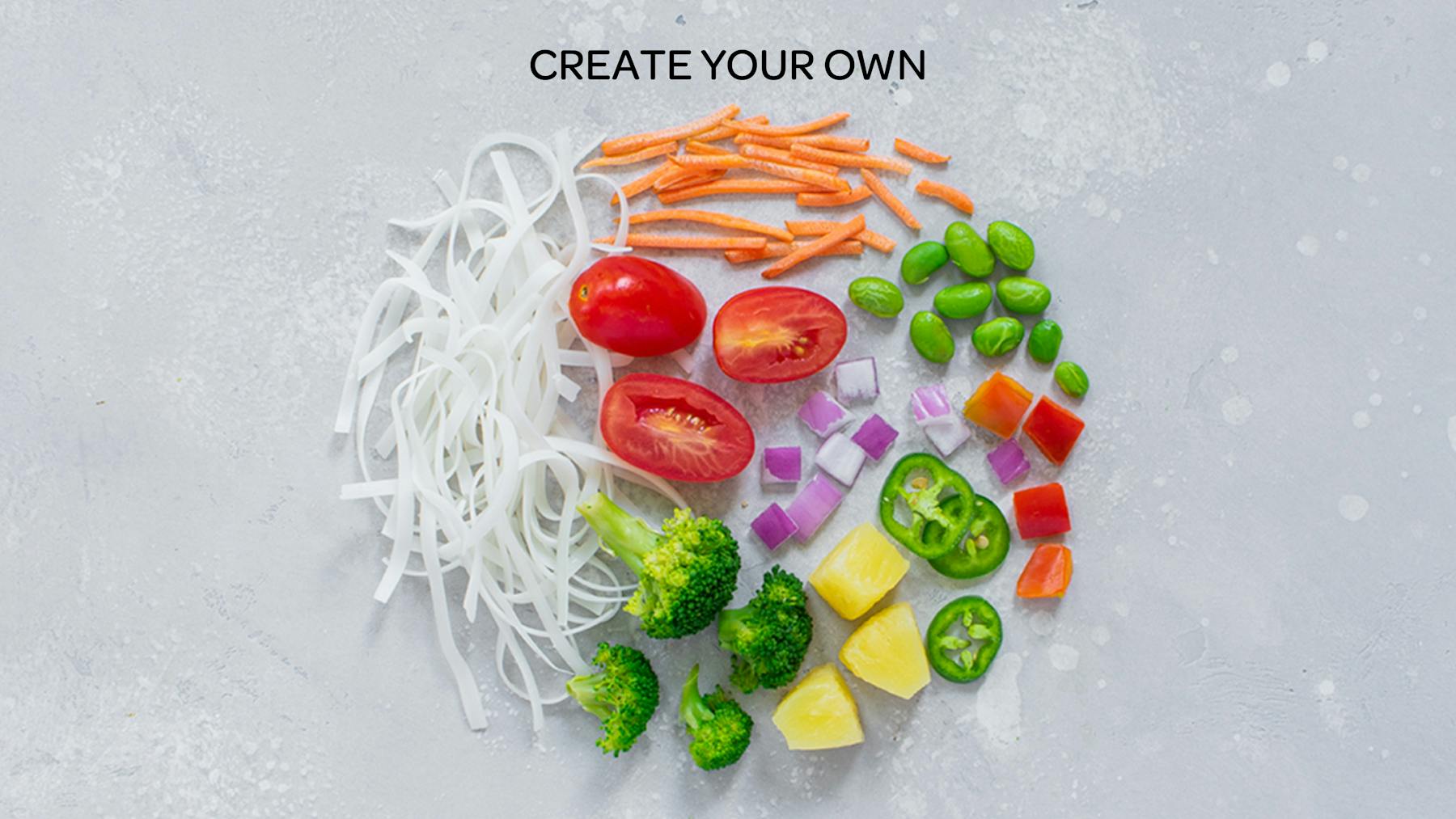 a close up of vegetables and noodles on a table