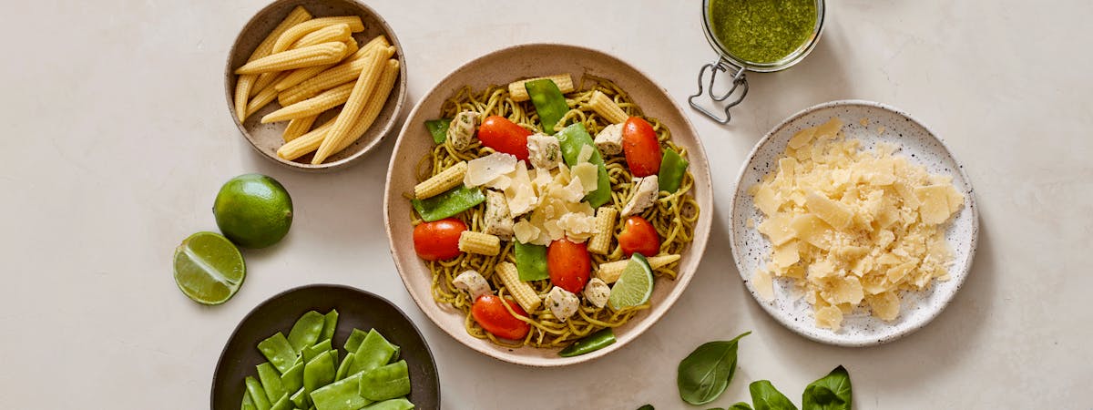 Freshly made egg white noodles, roasted chicken, grape tomatoes, snow peas, baby corn, shaved parmesan, fresh lime, and our basil pesto sauce