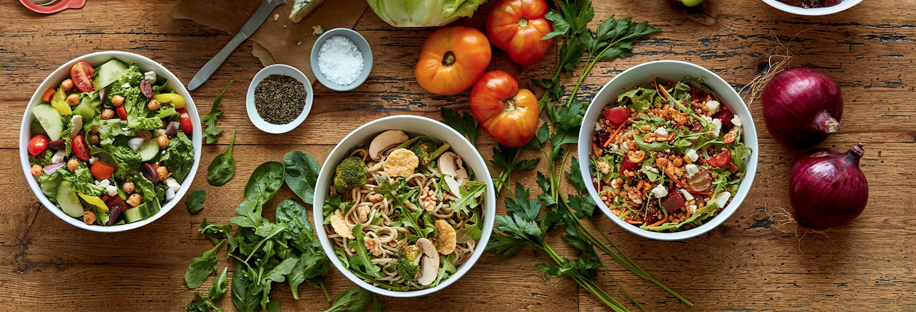 a bunch of food sitting on top of a wooden table