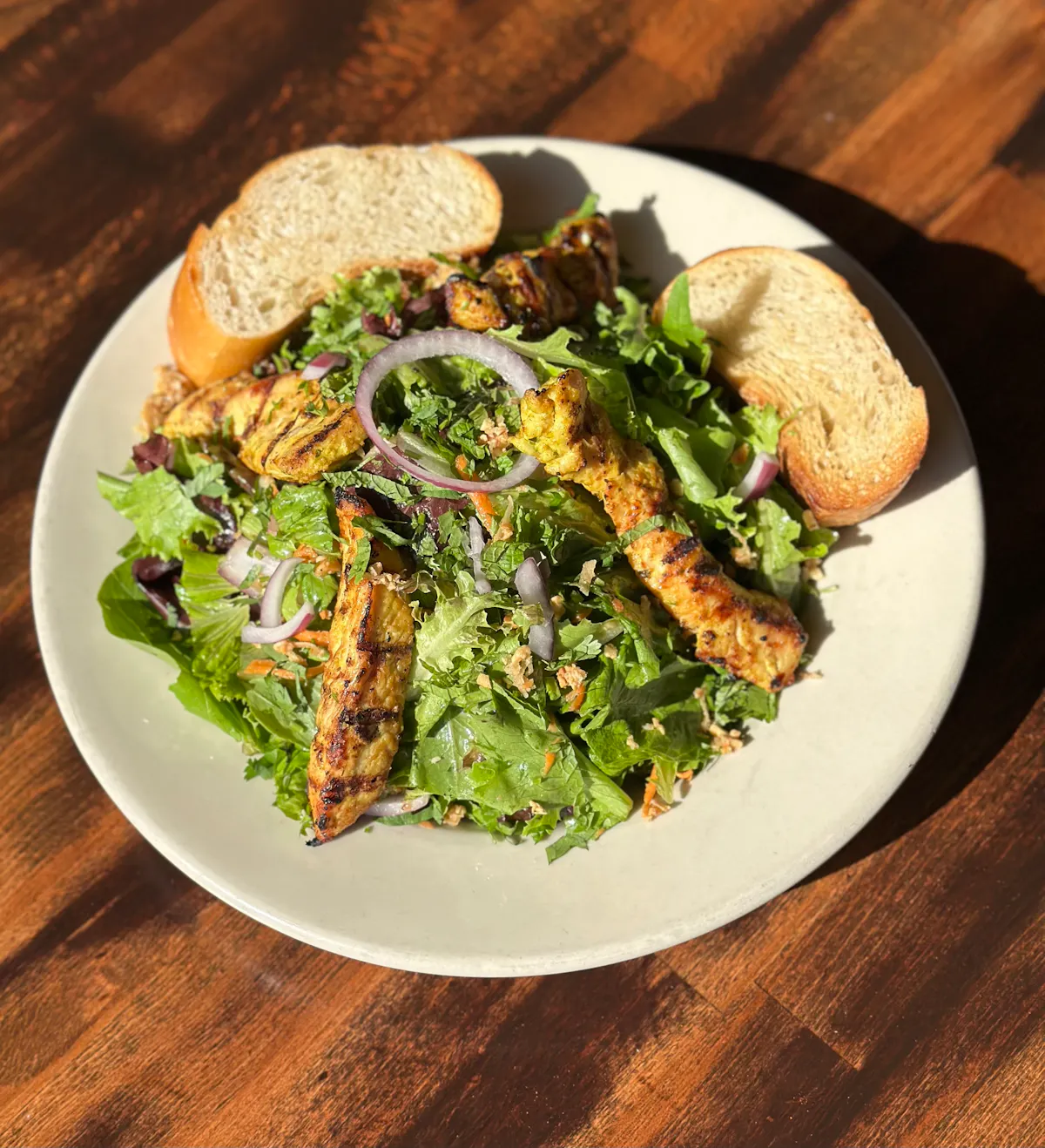 a plate of food sitting on top of a wooden table