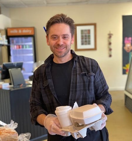 a man sitting at a table with a cup of coffee