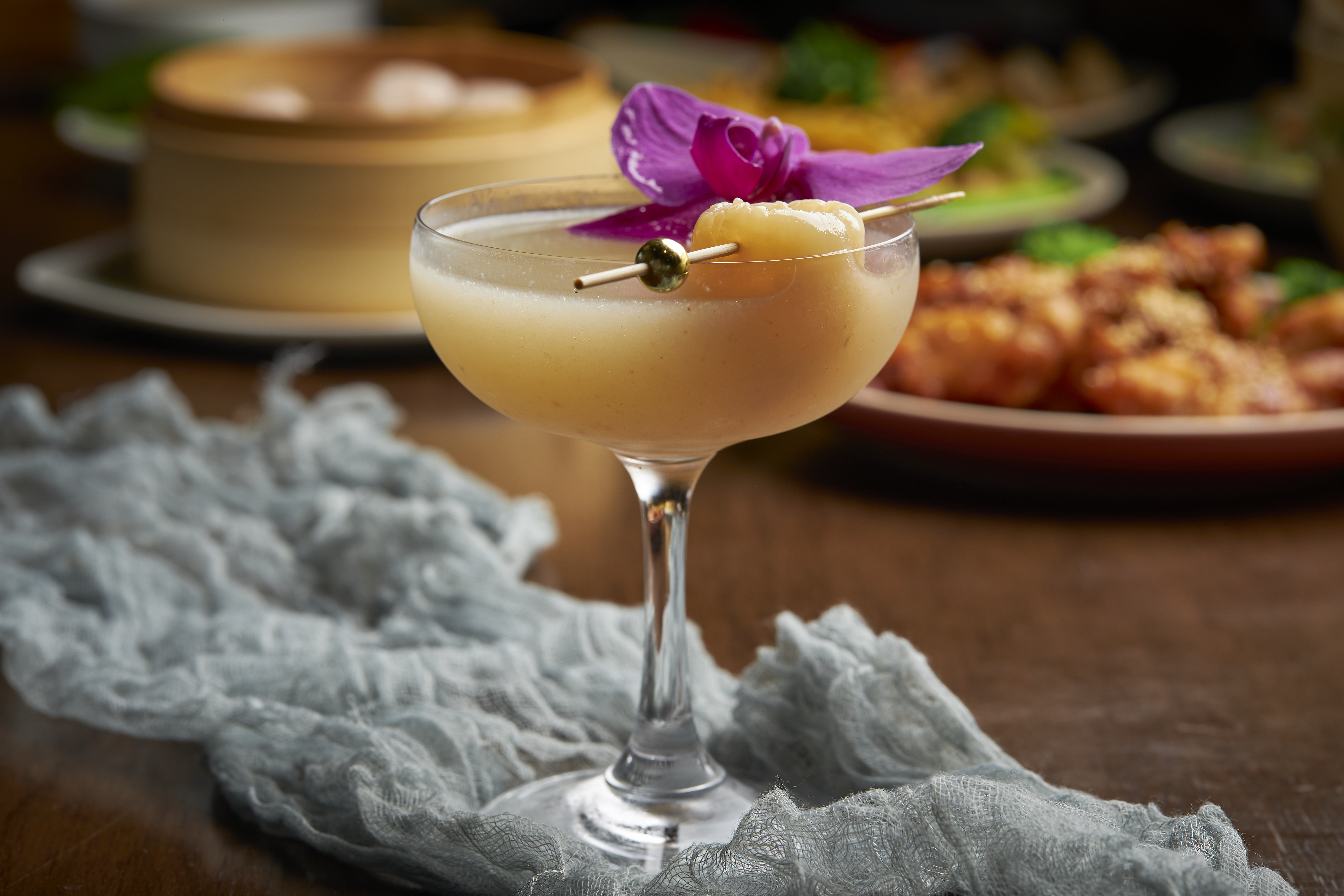 a glass of wine sitting on top of a wooden table