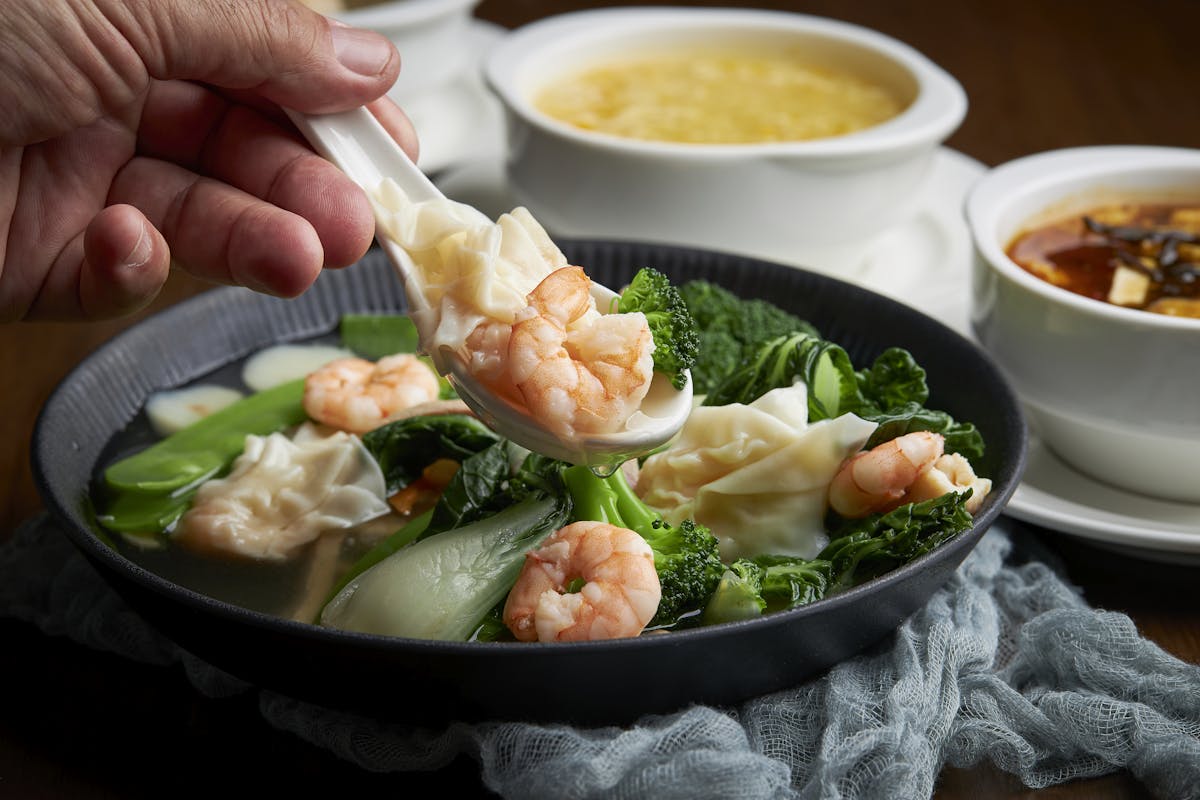 a person holding a bowl of food