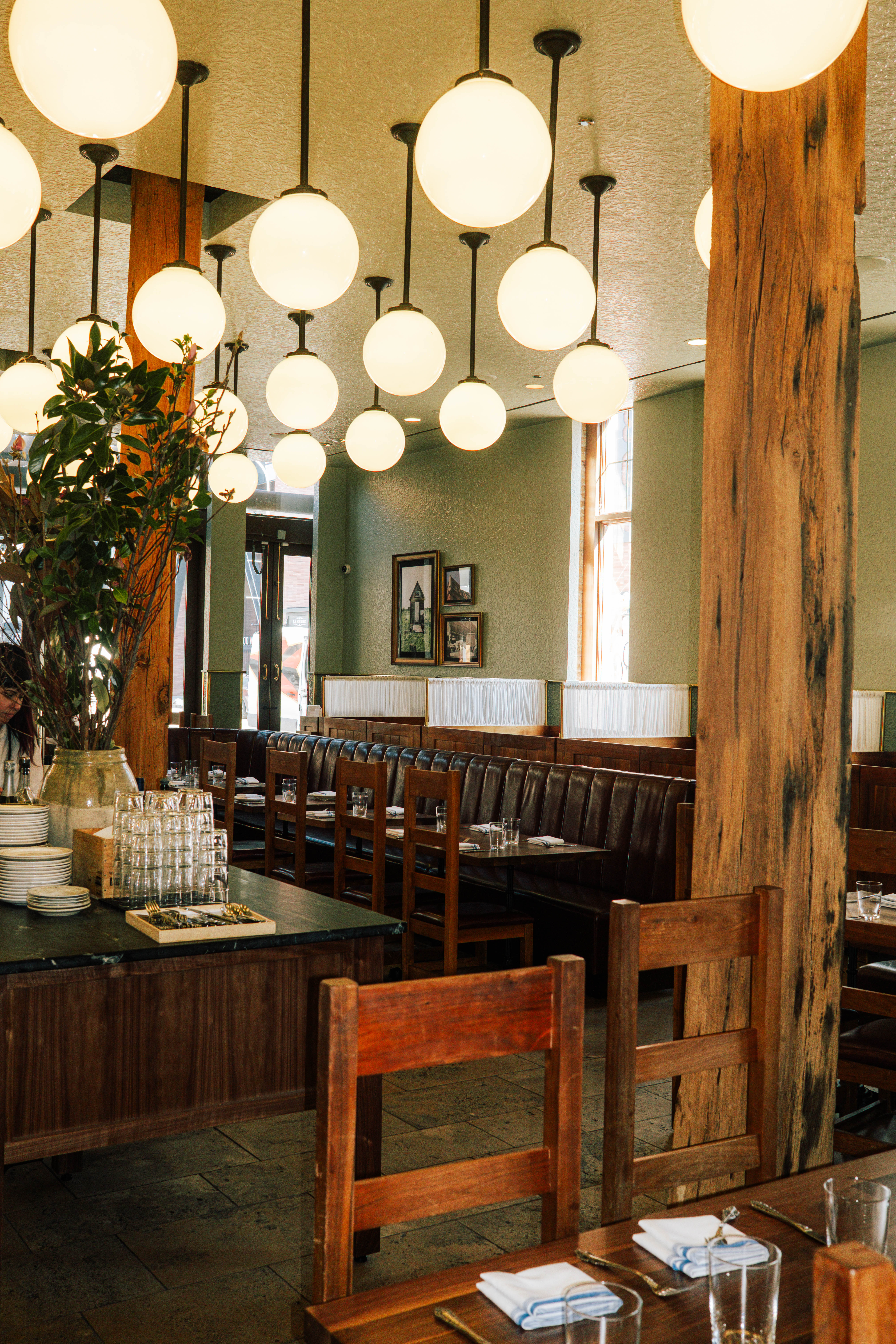 a restaurant with a large table and chairs