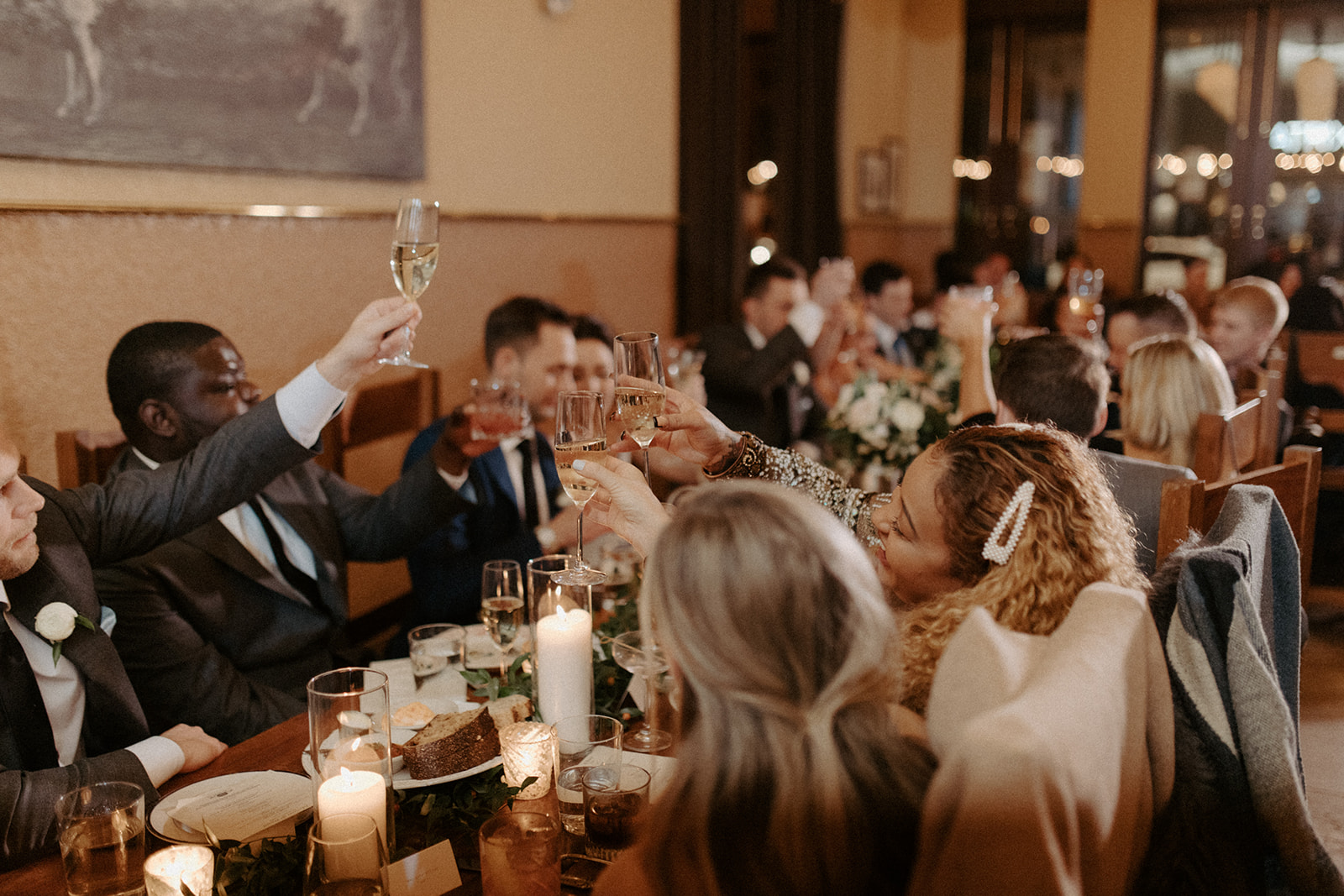 a group of people sitting at a table with wine glasses