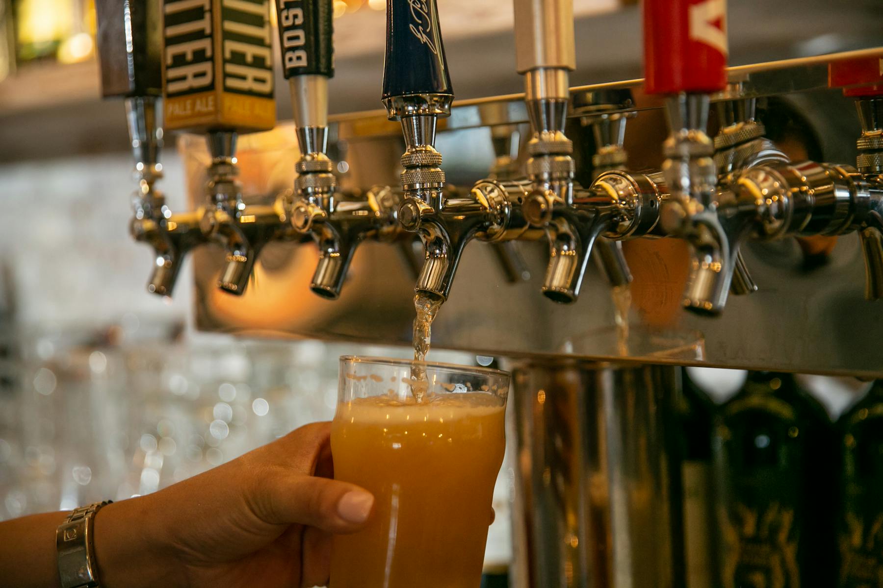 a person serving a drink from a machine