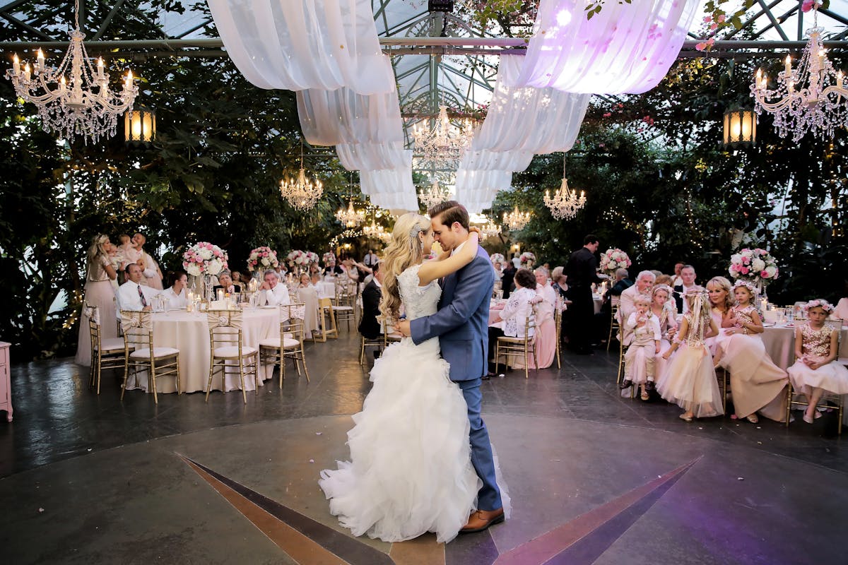 the bride and groom kissing while dancing