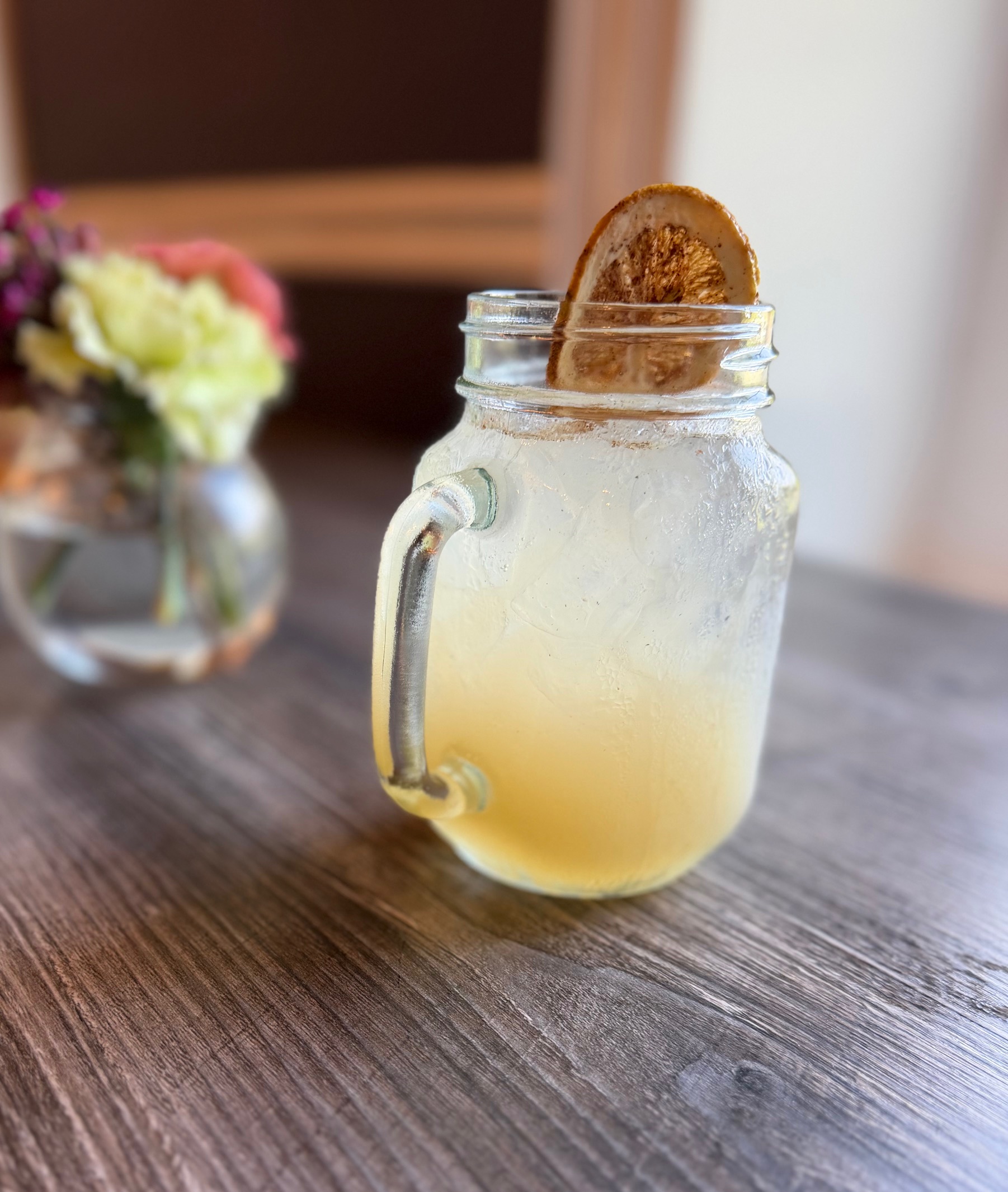 a glass with a drink and a slice of lemon