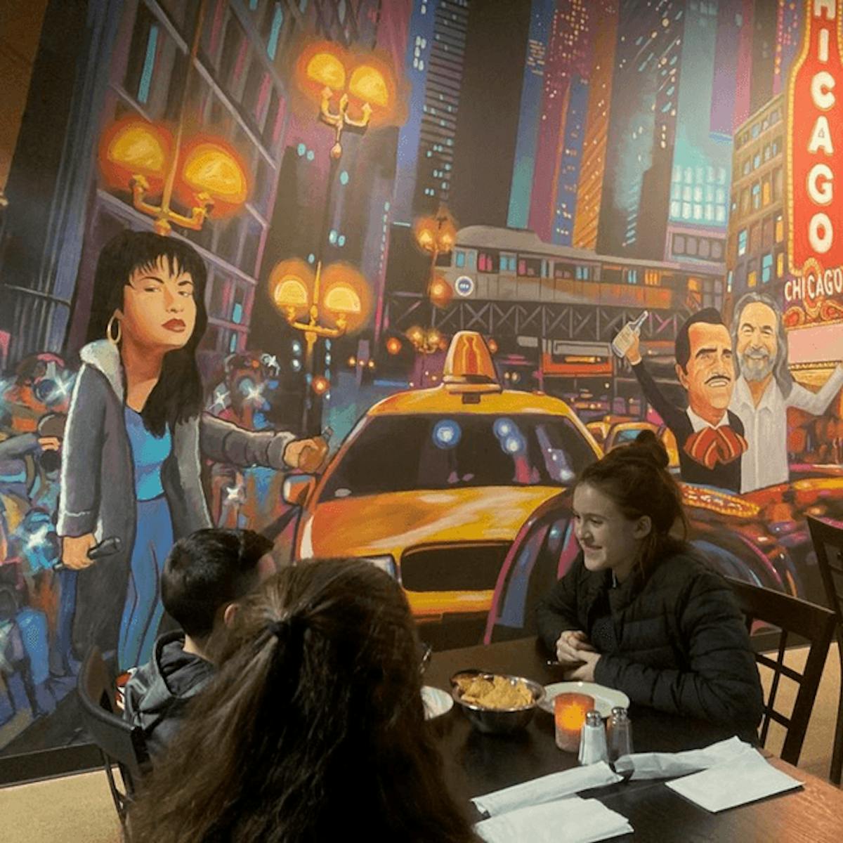 a group of people sitting at a table in a restaurant