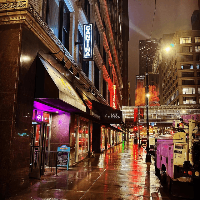 a group of people walking on a city street