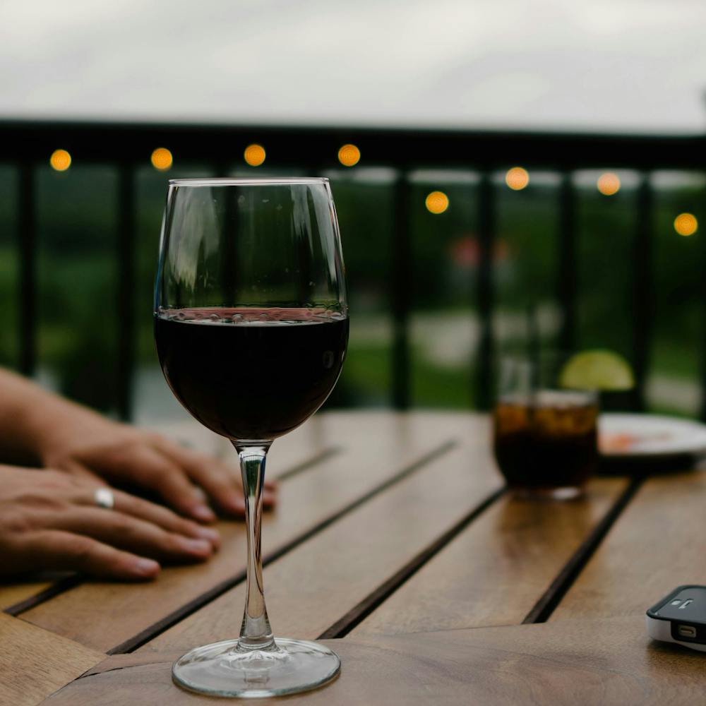 a hand holding a glass of wine