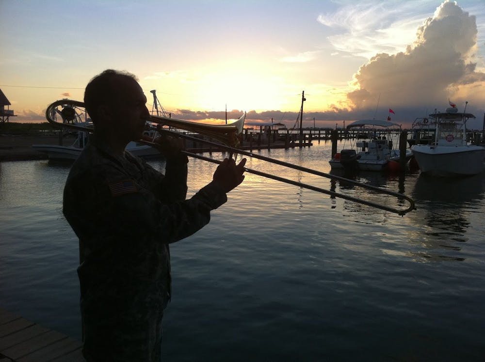 a man standing next to a body of water