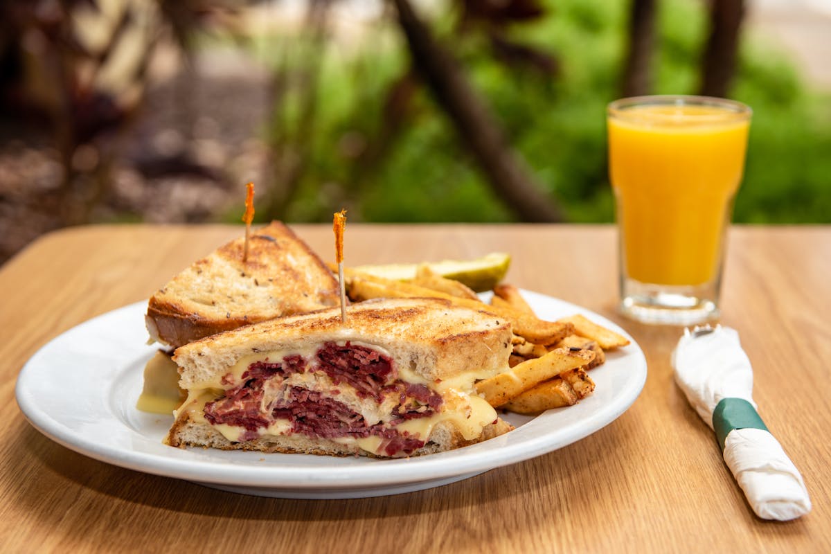 a close up of a plate of food and a drink on a table