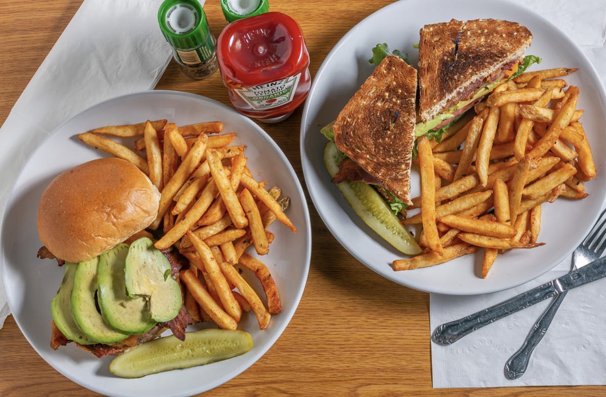 a plate of food with a sandwich and fries on a table