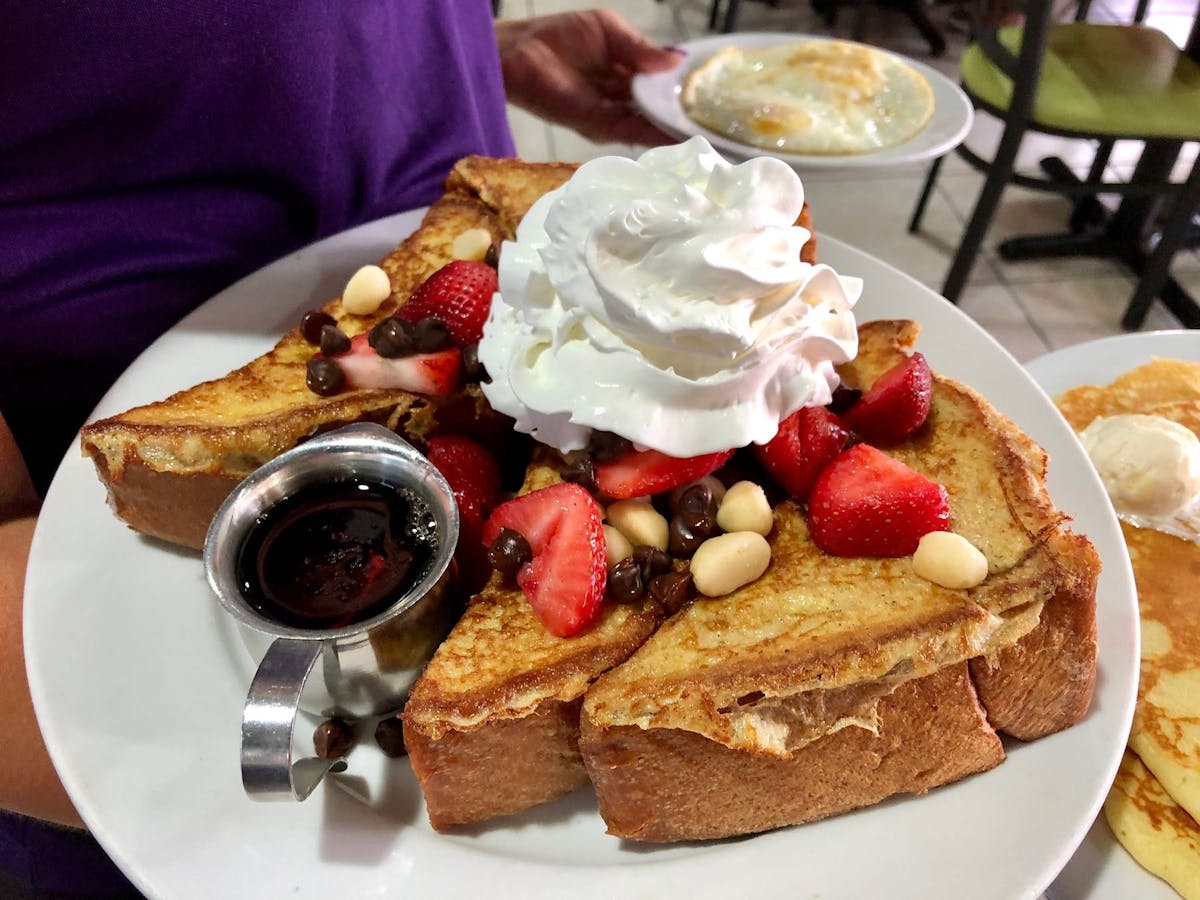 a plate of food with a slice of cake on a table