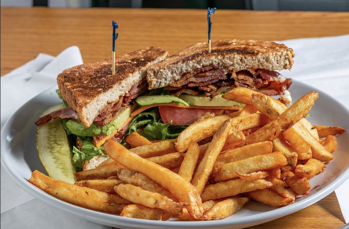 a close up of a sandwich and fries on a plate