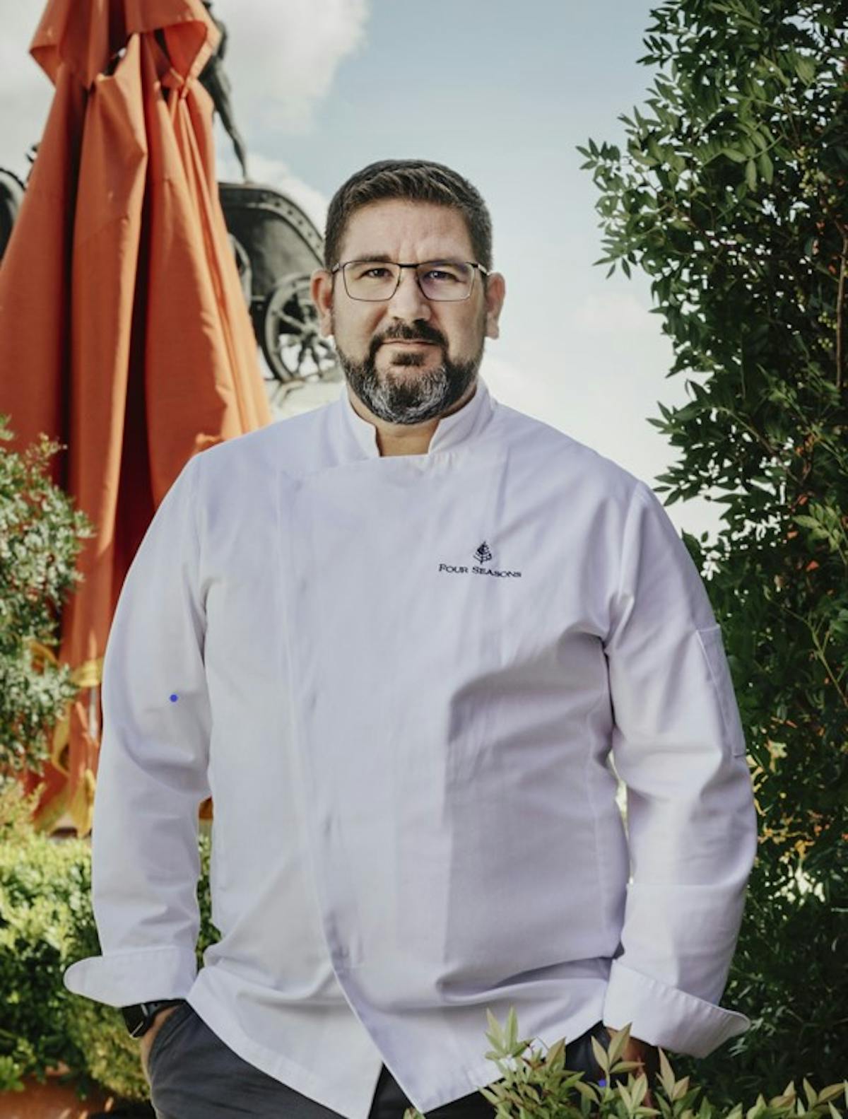 Chef Dani Garcia standing at on the roof top patio at Dani Brasserie at Four Seasons Hotel Madrid