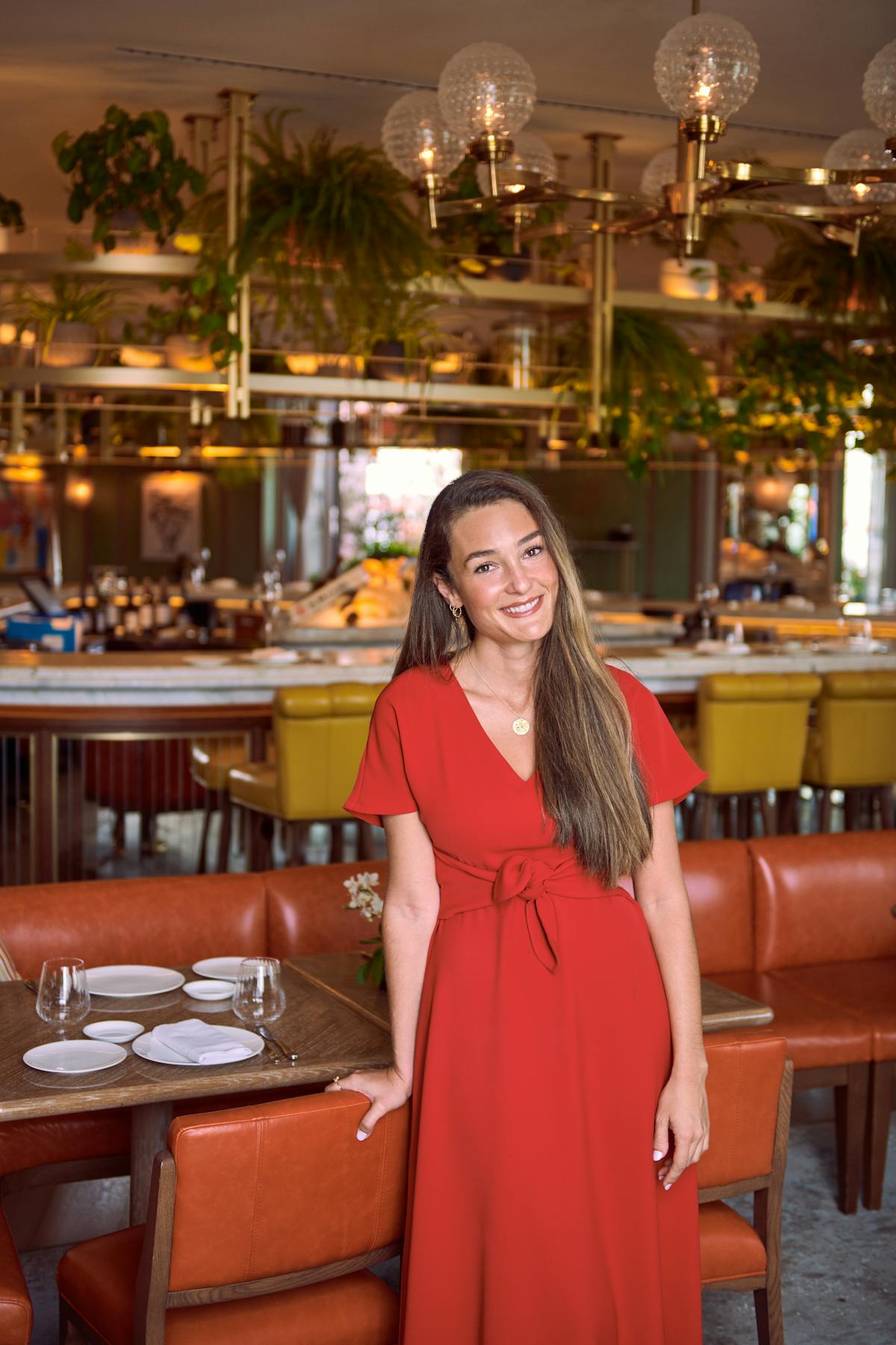 a woman standing in front of a restaurant