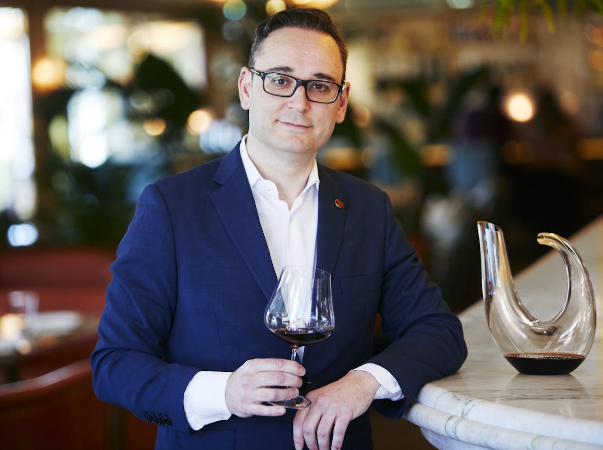 a man holding a glass of wine