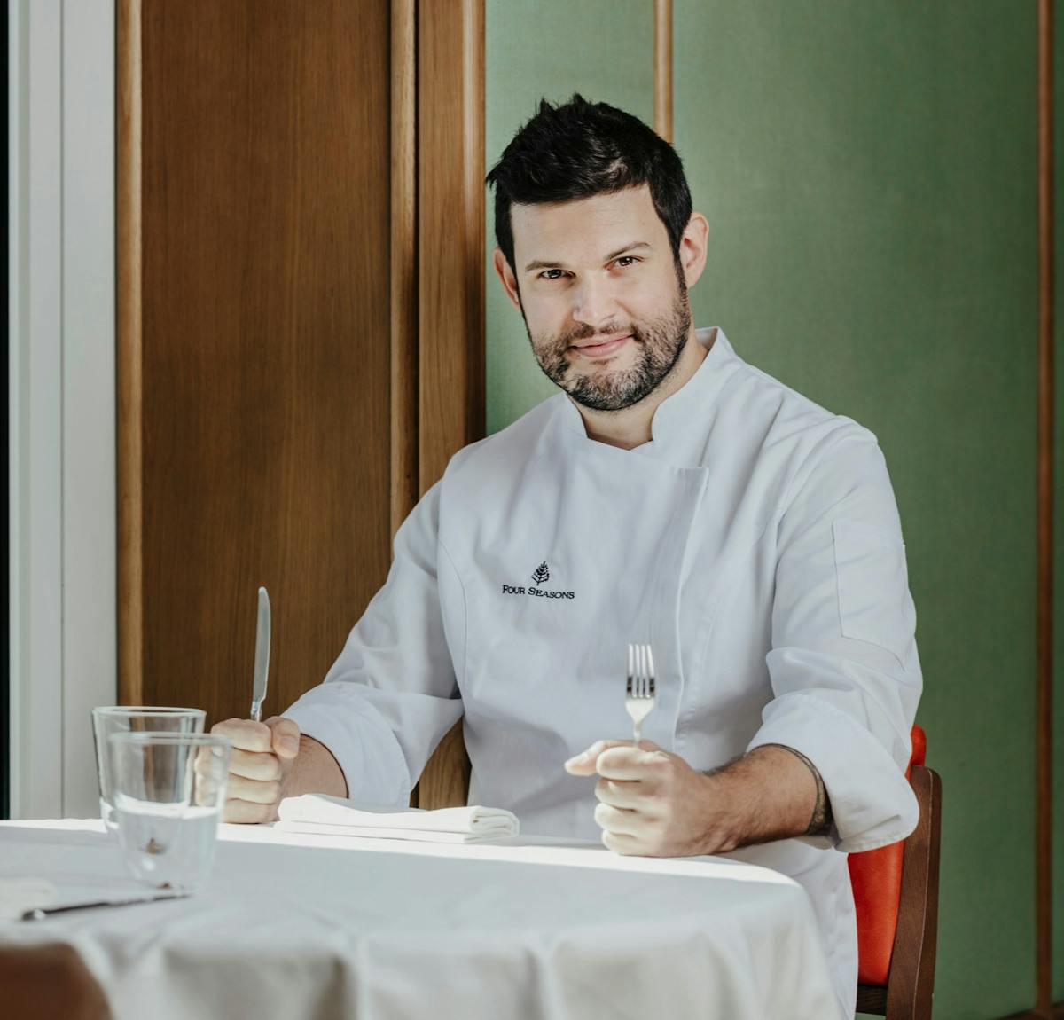 Chef Ismael Paul sitting at Dani Brasserie at Four Seasons Hotel Madrid