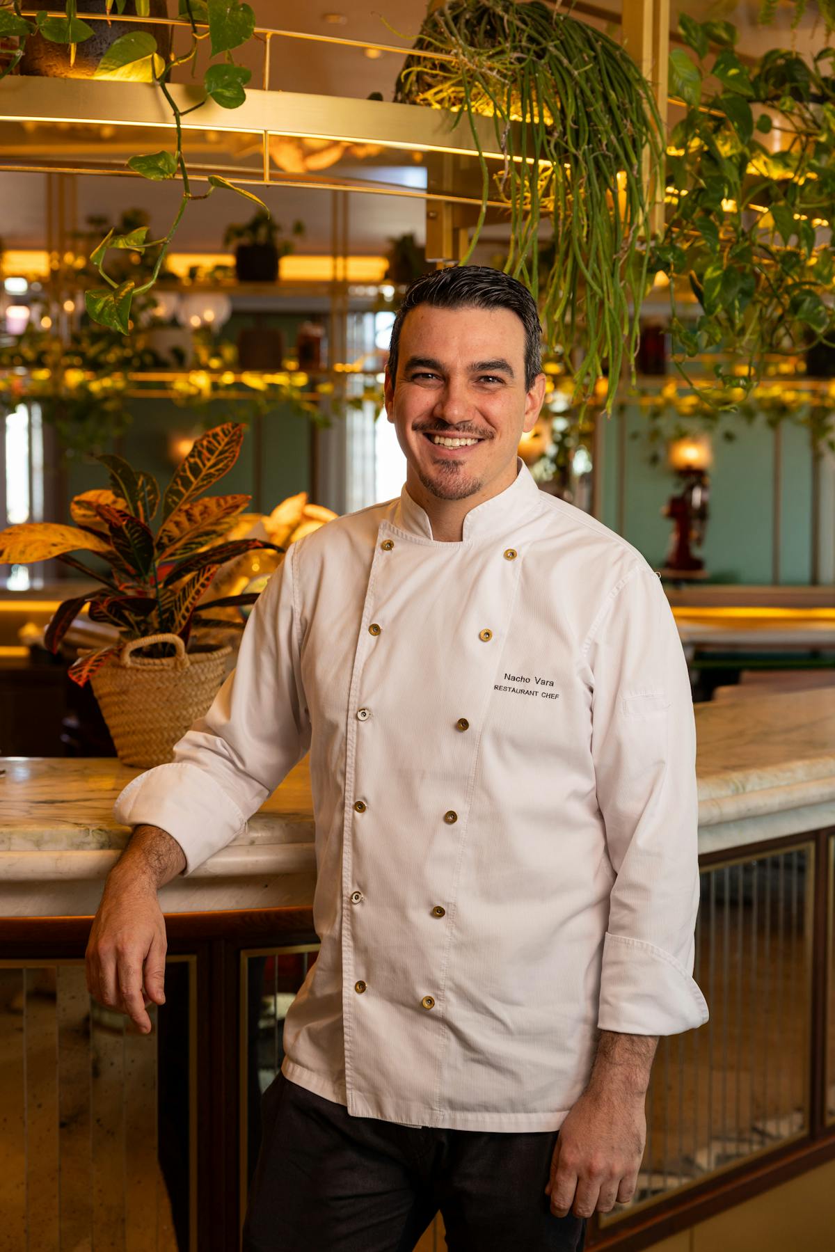 a man standing in front of a restaurant