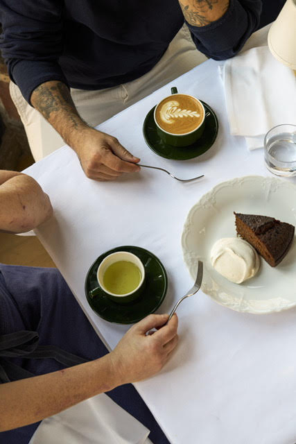 a man sitting at a table with a plate of food