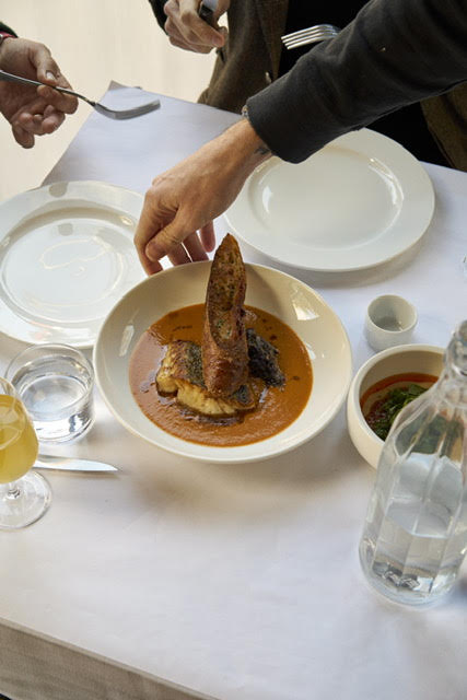 a man sitting at a table with a plate of food