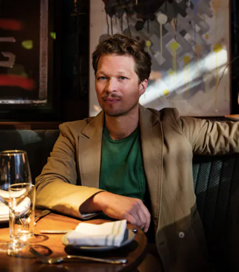 a person sitting at a table in a restaurant